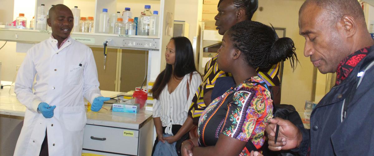 Lab Scientist, explaining laboratory process to visitors at the BHP Laboratory